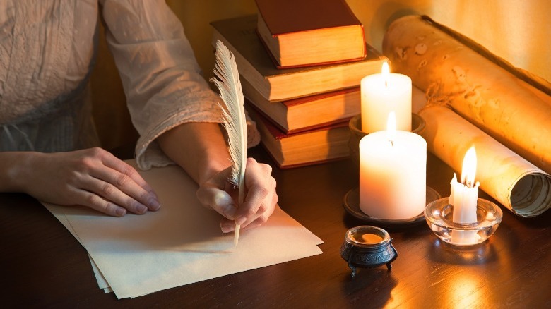 Woman writing at antique desk