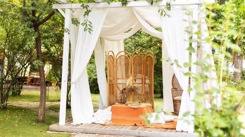 White pergola in yard