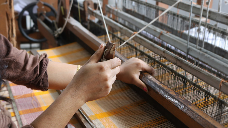 woman weaving material