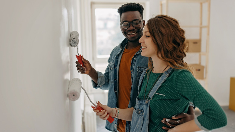 A couple painting the interior of their home