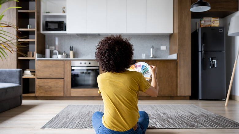 woman looking through paint colors