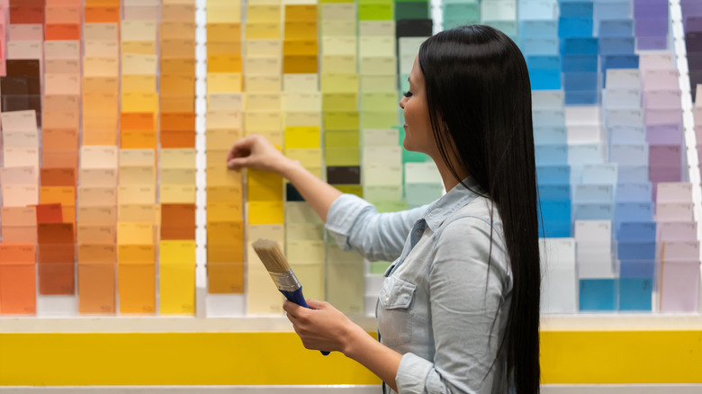 woman picking out new paint color