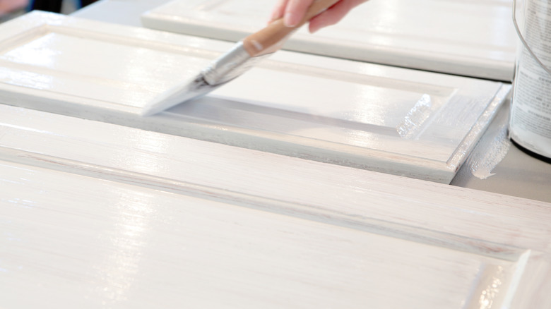 woman painting kitchen cabinets 