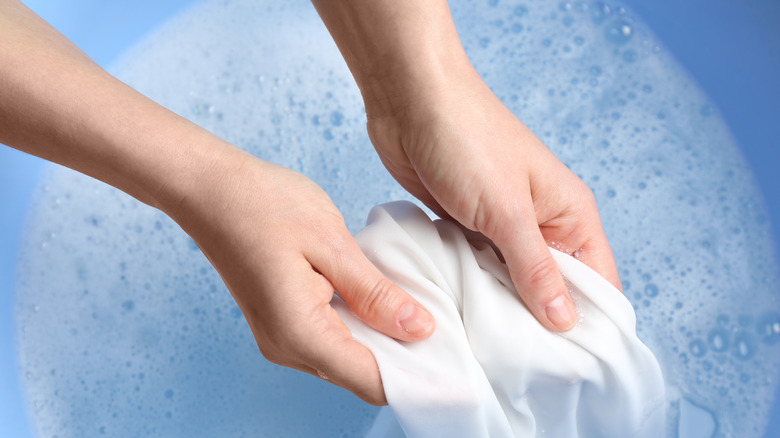 Person washing white linens