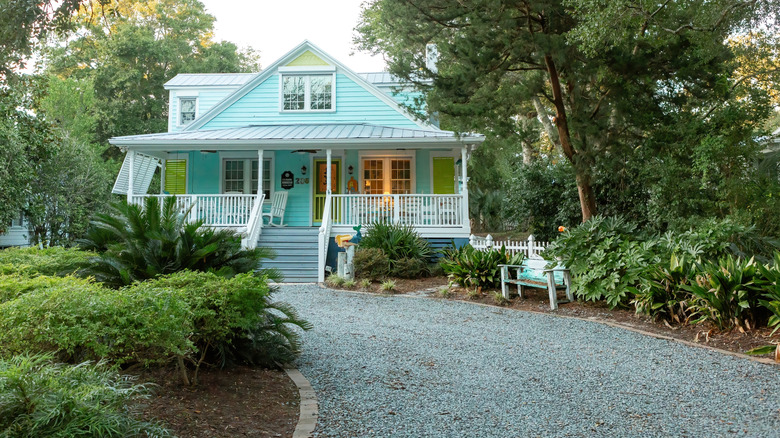 Attractive gravel driveway leading to a house