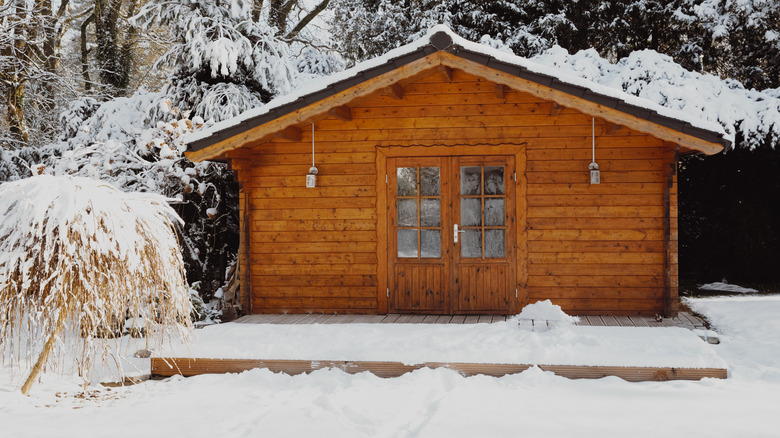 Wooden shed in snow