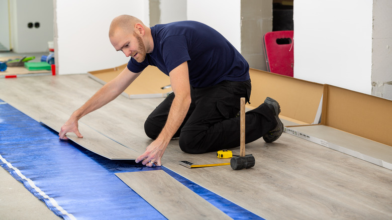 Person laying hardwood floors