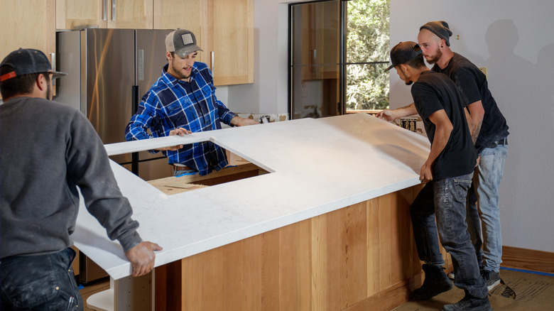 men removing old countertop