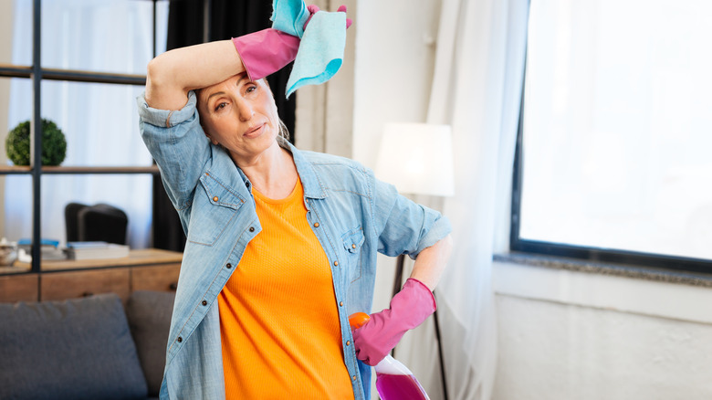 tired woman cleaning home