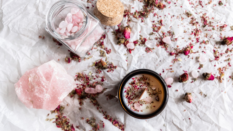 Candle with dried flowers and rose quartz