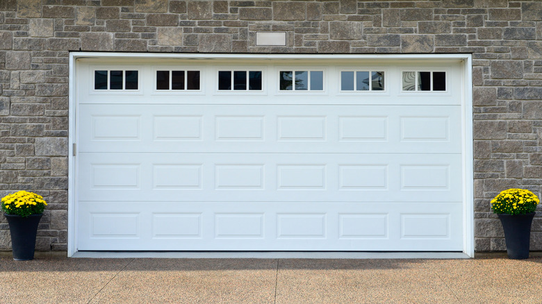 A garage door with windows along the top