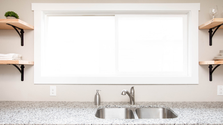 Wood shelves framing kitchen window