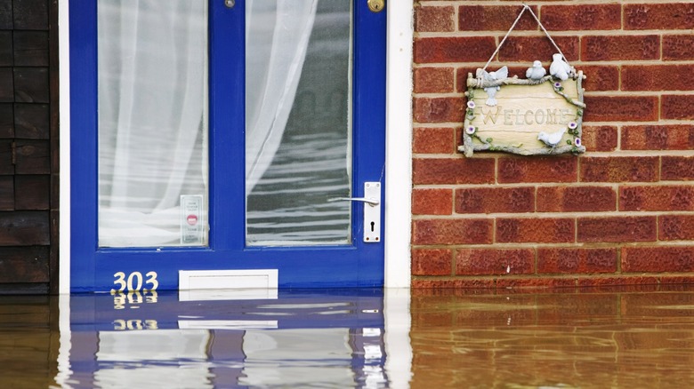 Blue front door of flooded house