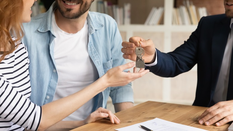 Person handing over keys