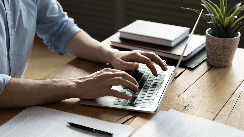 Person typing on laptop