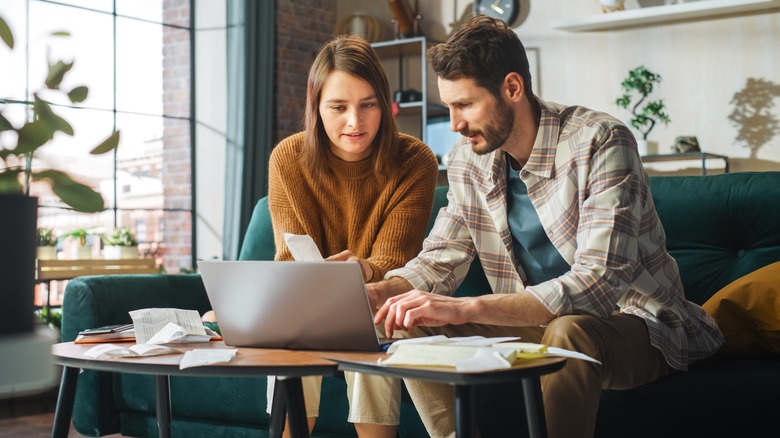 Couple paying bills on laptop