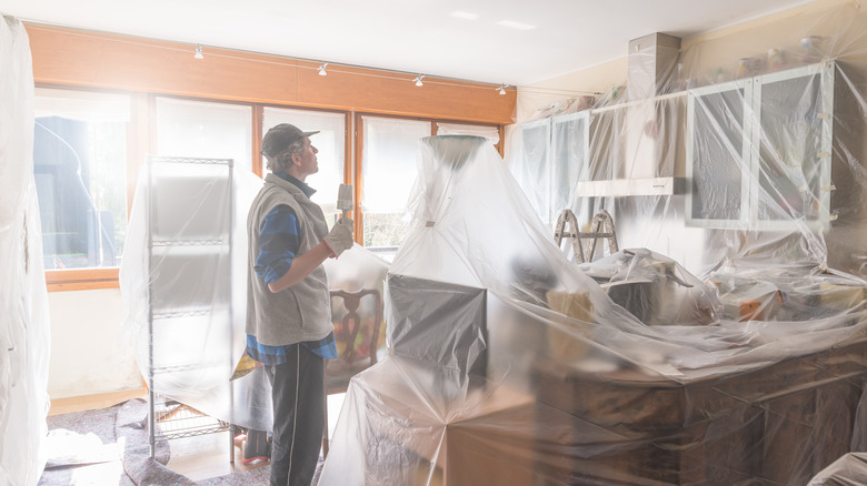 kitchen covered with plastic wrapping