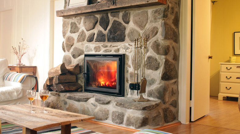 Living room with a natural stone fireplace in a contemporary home.