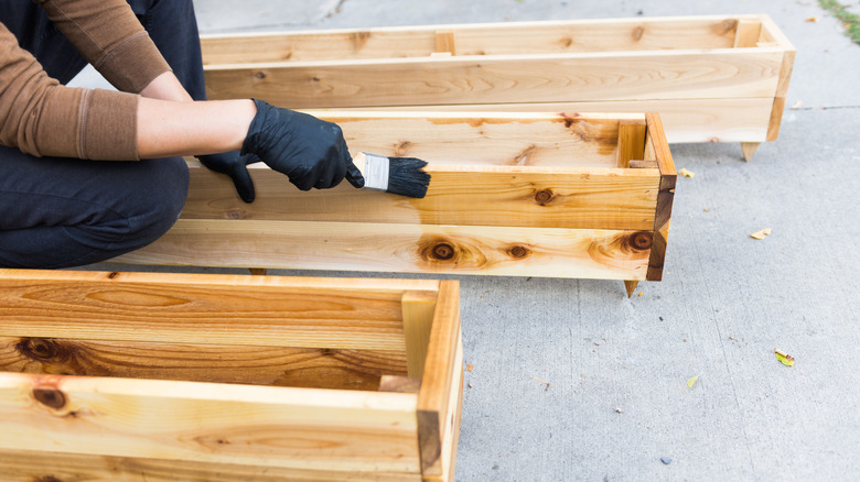 Person finishing cedar planters