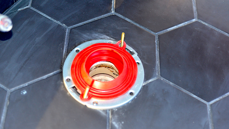 Wax-free toilet ring installed over geometric tile flooring