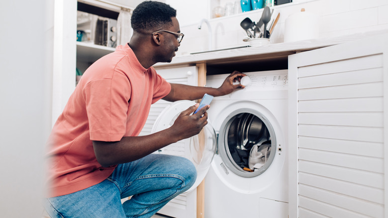 man doing laundry at home