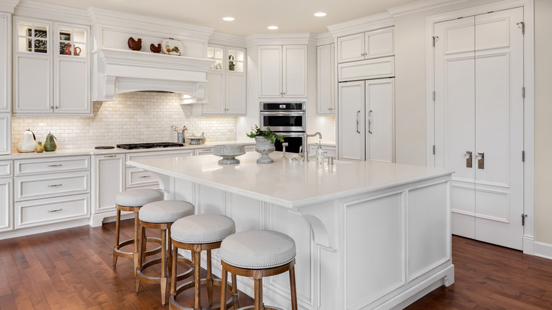 White kitchen with brown floor