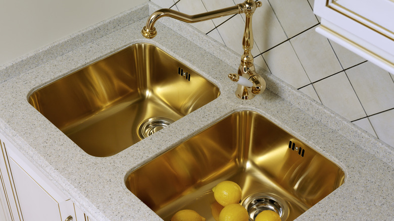 A shiny brass sink with brass faucet