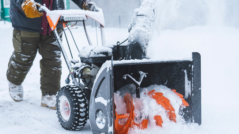 Person using snow blower