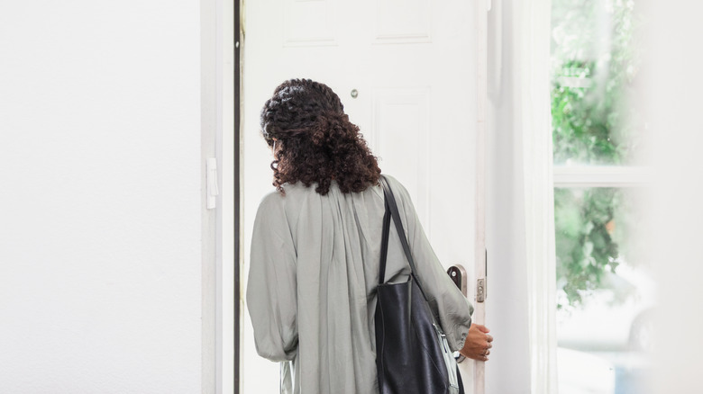 Woman exiting door