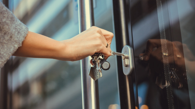 Person putting key in lock