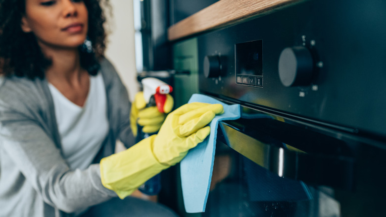 Woman cleaning oven