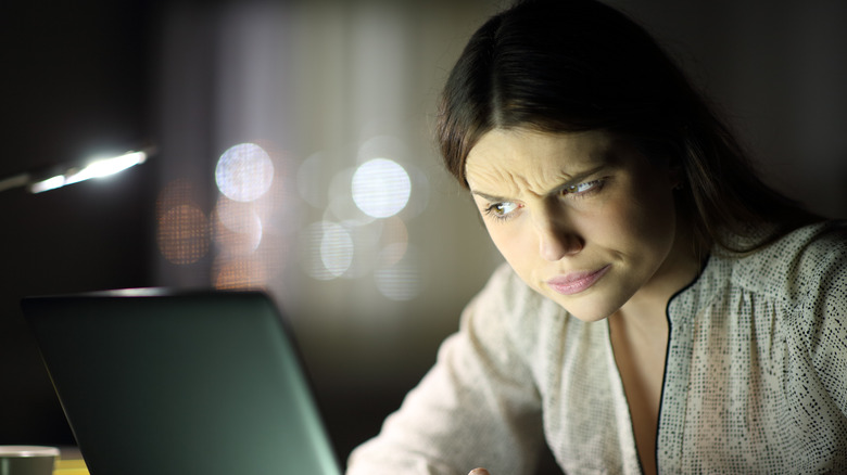 confused woman looking at laptop