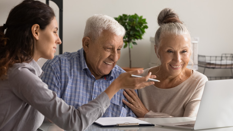 agent explaining something to couple