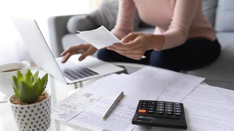 woman with receipts and calculator