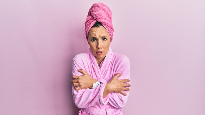 Cold woman in bathrobe