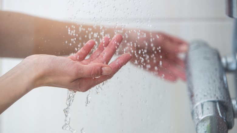 a hand under the shower