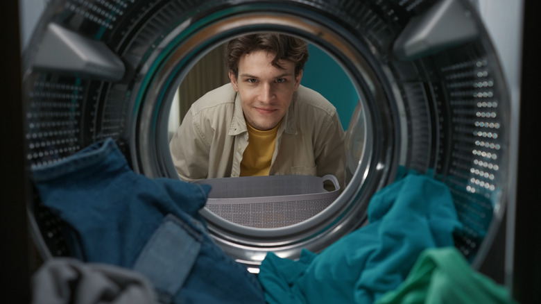 A person looking into a washing machine