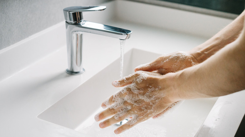 washing hands in bathroom sink