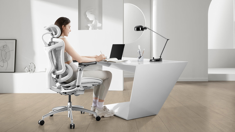 Woman sits at desk in white Sihoo C300 Pro chair