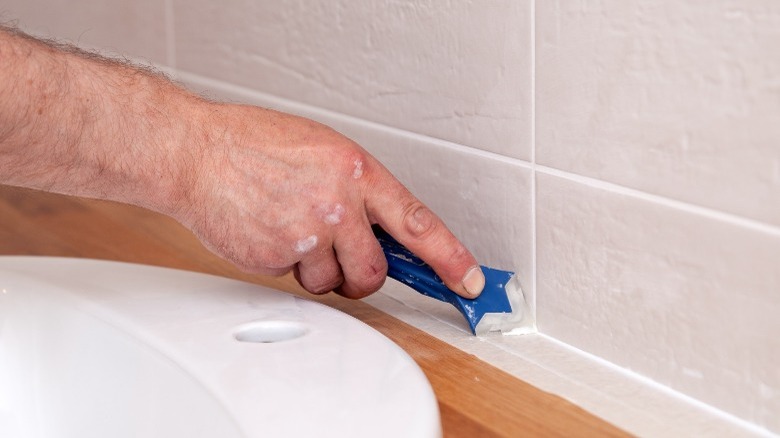 hand with a grout tool