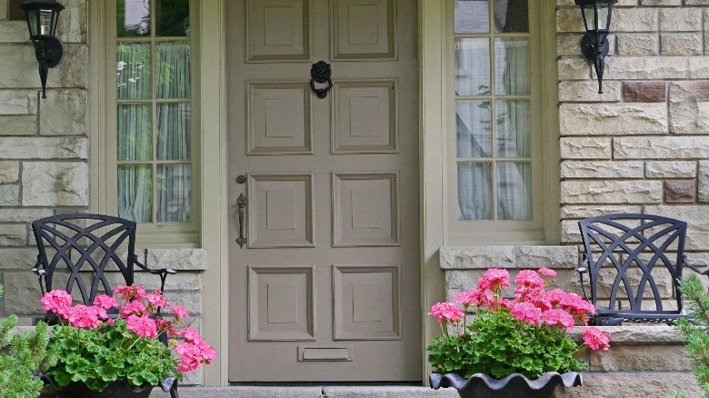 Front porch with pink flowers in pots