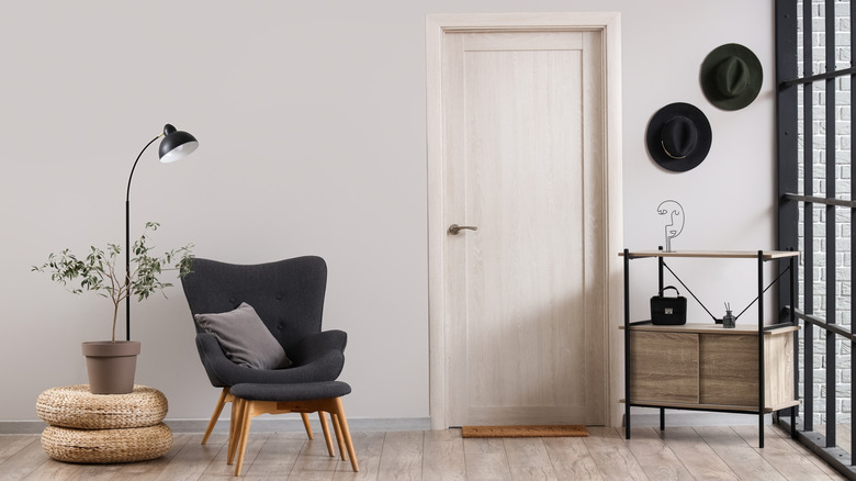 Home interior with white door and black chair