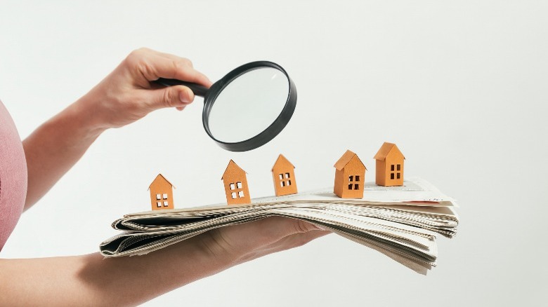 Magnifying glass looking at houses 