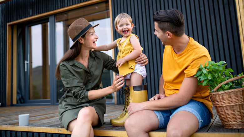 Young family outside home