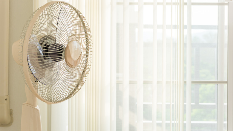 standing fan near window