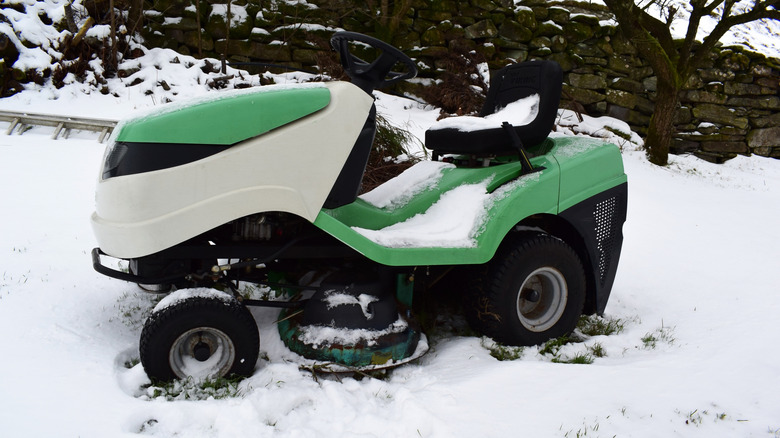 A riding lawnmower in the snow