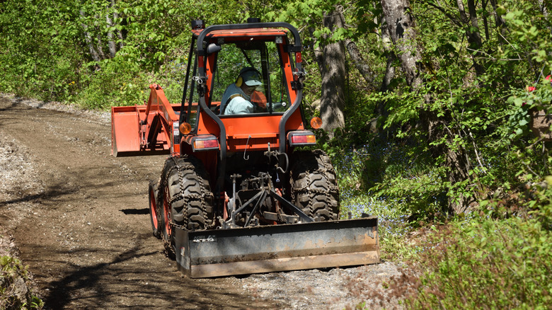 Tractor grading a rural driveway