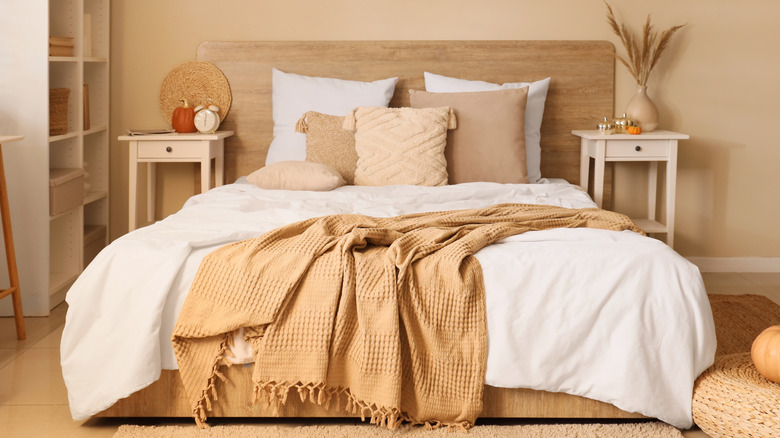 Chic soft bed with white sheets and pillows