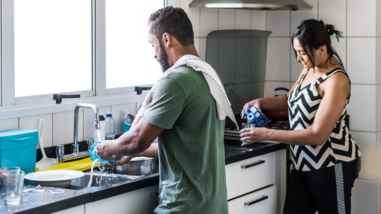 Couple washing dishes together