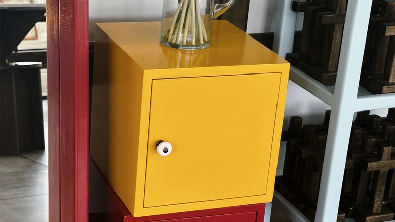 A home is decorated with a yellow storage cube